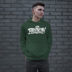 Young man modeling the Brooklyn Handstyle Hoodie, featuring a white graffiti-style BROOKLYN logo with a halo on a dark green pullover. He's standing casually with hands in the kangaroo pocket.