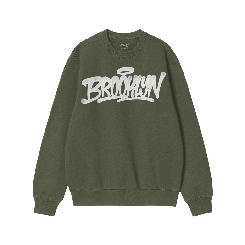 Forest-green crewneck sweatshirt featuring a white Brooklyn graffiti handstyle graphic with a halo, reflecting bold individua