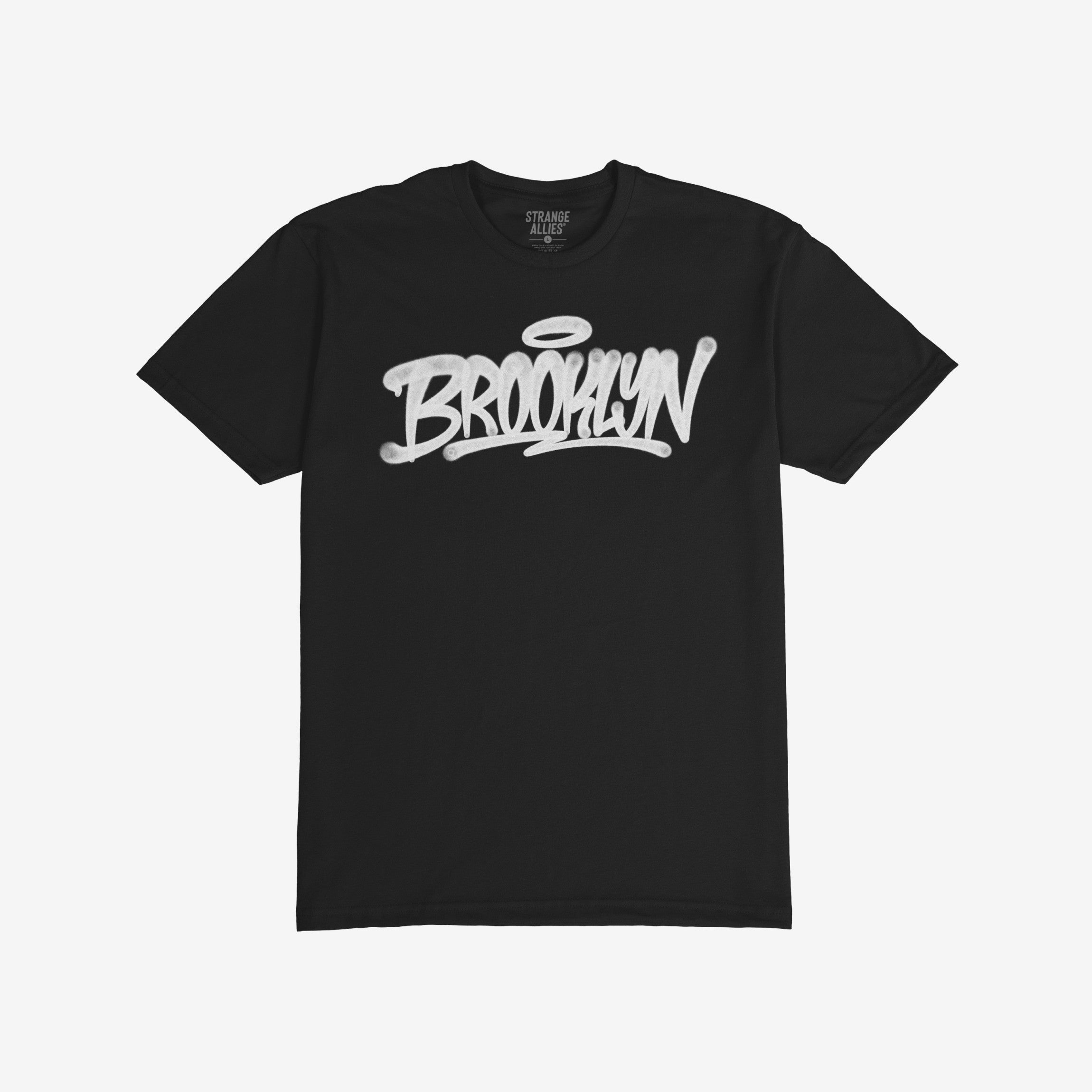 Brooklyn Handstyle T-shirt featuring “Brooklyn” in graffiti-style white letters with a halo motif, reflecting bold borough pride. Brand name Strange Allies visible inside collar.