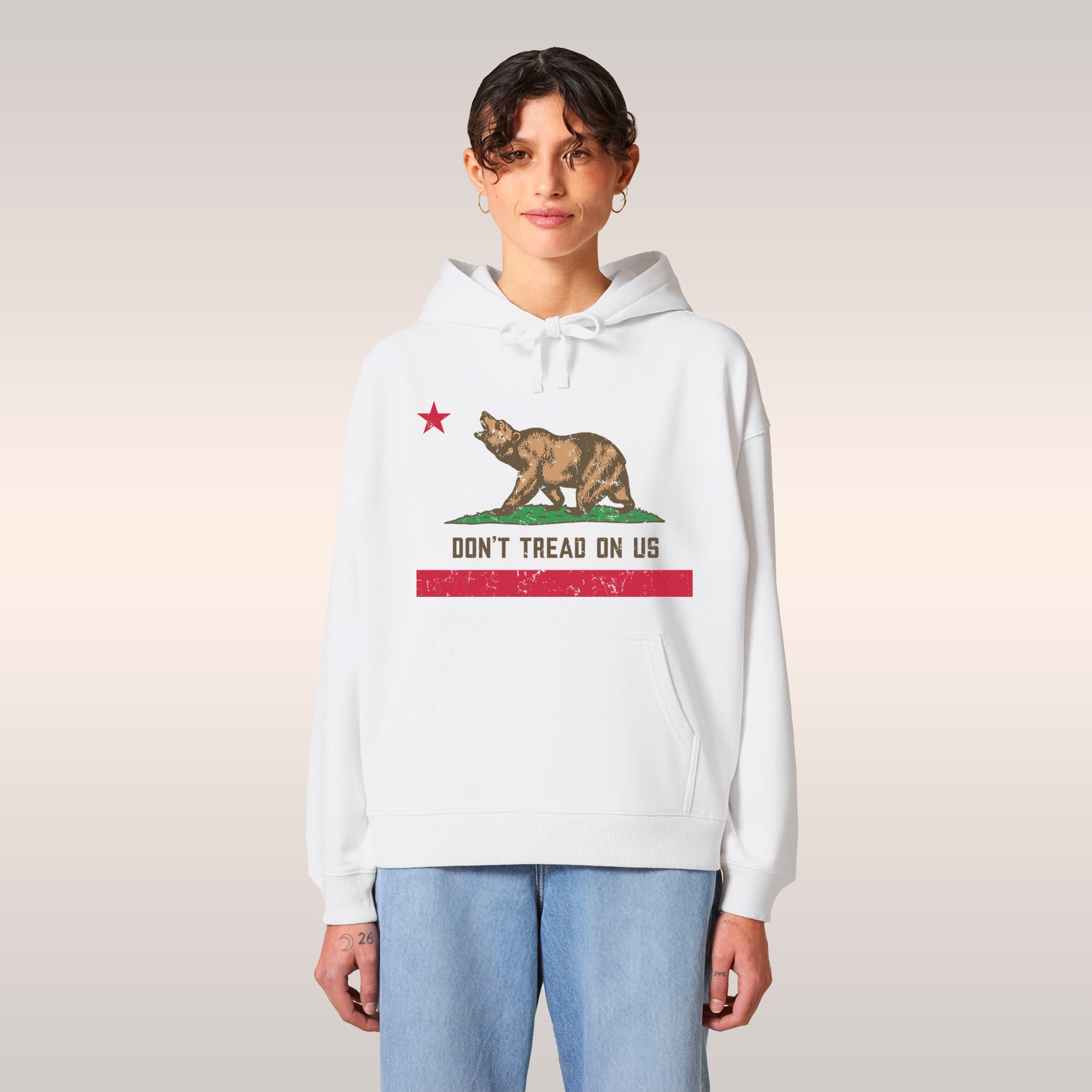 Young man with dreadlocks in a vintage car wears the California Gadsden Flag Shirt featuring a bear and DON'T TREAD ON US slo