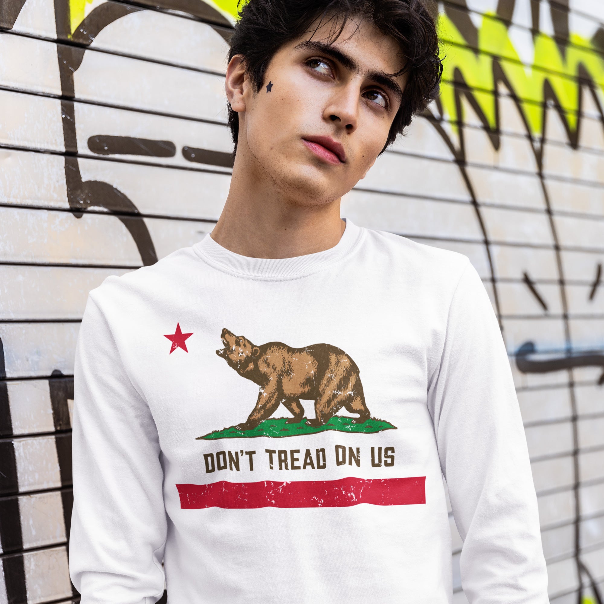 Young man wearing the California Gadsden Flag Shirt featuring a bear, red star, and DON'T TREAD ON US slogan, symbolizing state pride and resistance against oppression. Perfect for advocates of equality and justice.