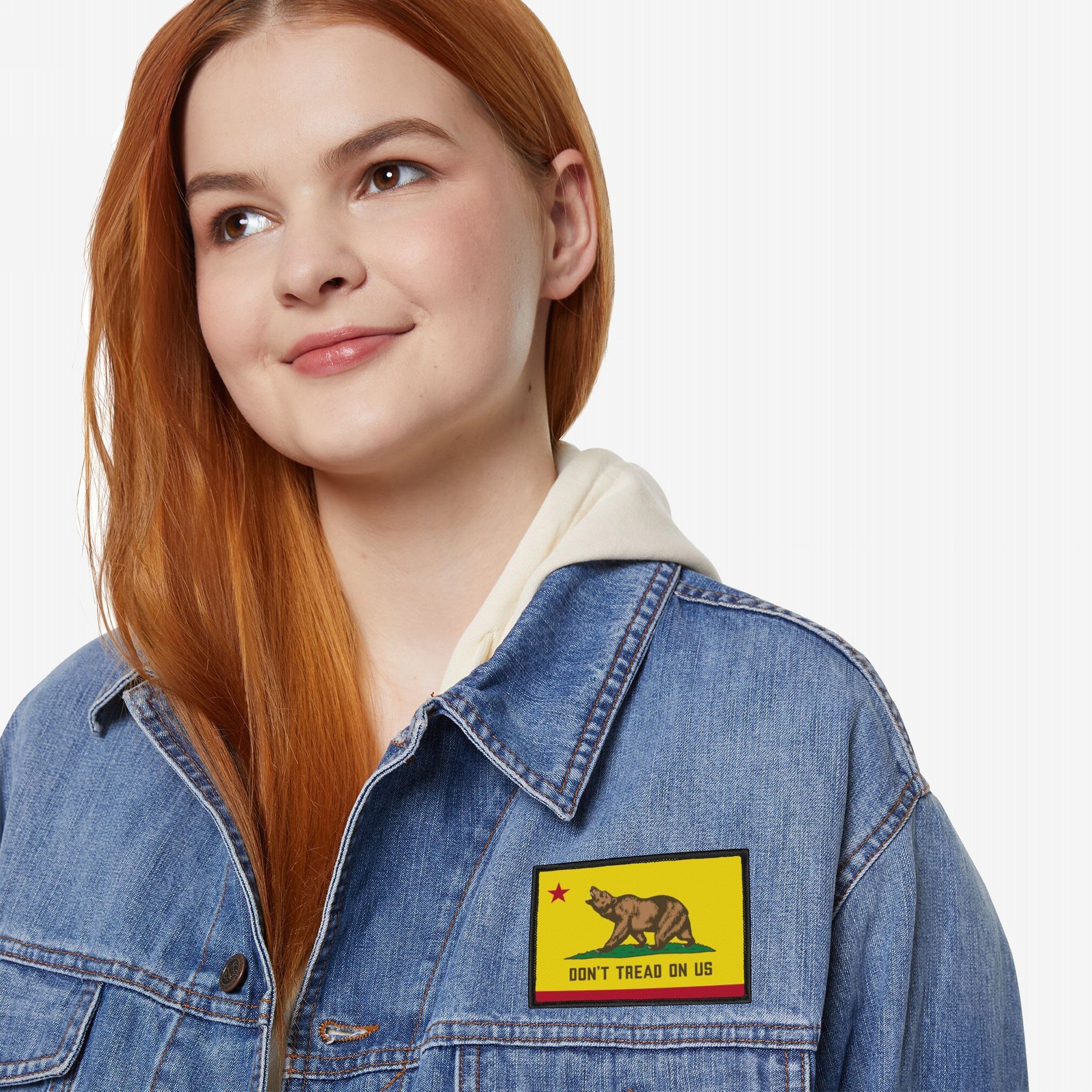Young woman wearing a light-wash denim jacket with the California Gadsden Flag Patch, featuring a bear and Don't Tread on Us slogan, symbolizing radical defiance and state pride.
