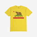 California Gadsden Flag Shirt with a bold bear graphic on grass, red star above, and DON'T TREAD ON US slogan. Features distressed red stripe, symbolizing resistance and state pride.