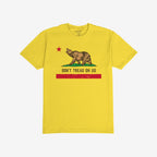 California Gadsden Flag Shirt with a bold bear graphic on grass, red star above, and DON'T TREAD ON US slogan. Features distressed red stripe, symbolizing resistance and state pride.