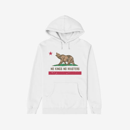 White hoodie featuring the California No Kings Flag Shirt design: a roaring bear on grass, red star above, slogan “NO KINGS NO MASTERS” below. Symbolizes rebellion and autonomy. Supports LAFLA.