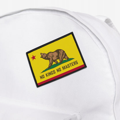 The California Flag No Kings Patch features a grizzly on grass with a red star, subtly styled with NO KINGS NO MASTERS text, symbolizing rebellion. Perfect for personalizing backpacks or apparel.