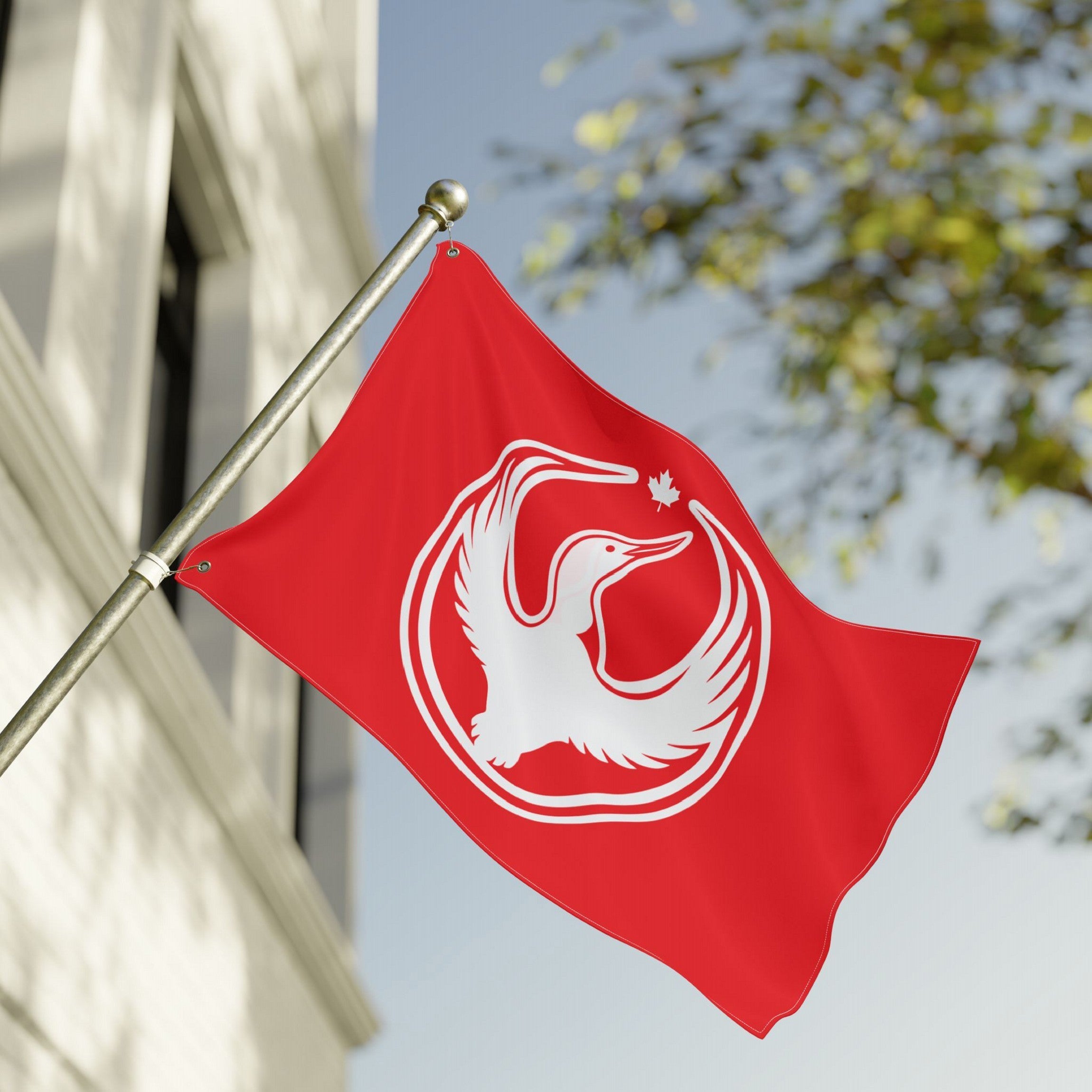 Canada Rebel Alliance Flag with a stylized loon and maple leaf emblem, symbolizing resistance and equality, mounted on a pole outside a building, ideal for rallies and community support.