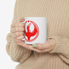 Person in a chunky beige knit sweater holds the Canada Rebel Alliance Mug, featuring a bold red bird graphic with a maple leaf, symbolizing activism and community support.