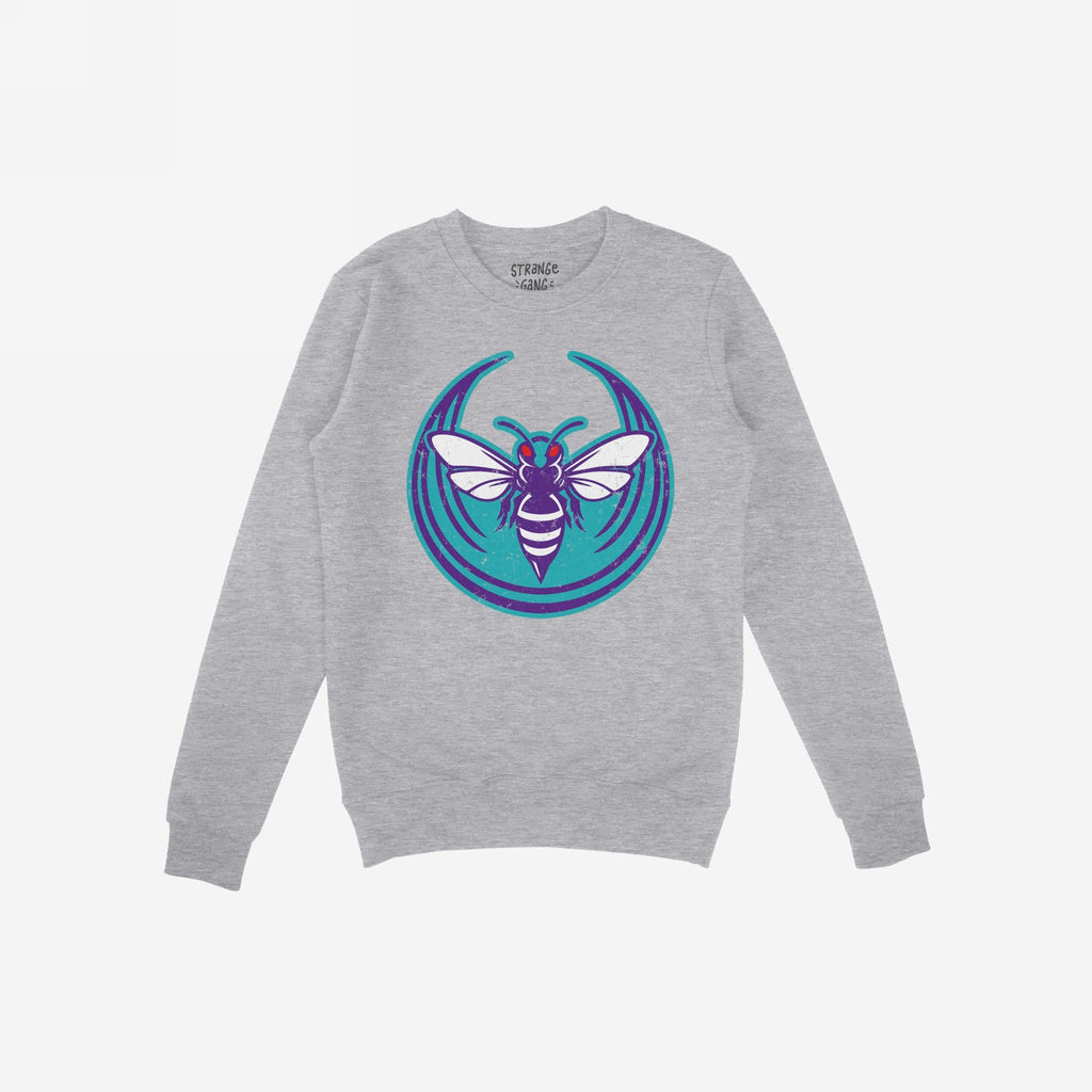 Charlotte Rebel Alliance Hoodie & Sweatshirt features a light-gray crewneck with a bold teal and purple insect emblem, symbolizing defiance. The phrase STRANGE GANG. is visible inside the collar.