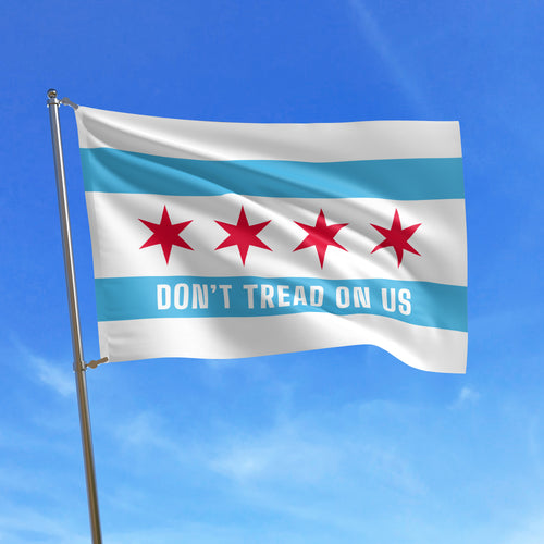 Chicago Gadsden Flag featuring four red stars and bold text DON'T TREAD ON US, set against a clear sky, symbolizing protest and resistance.
