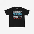 Chicago Hates Trump Women's Baby Tee features bold letters HEY TRUMP, CHICAGO HATES YOU with four red stars, capturing a protest spirit. Ideal for making a statement in support of equality.