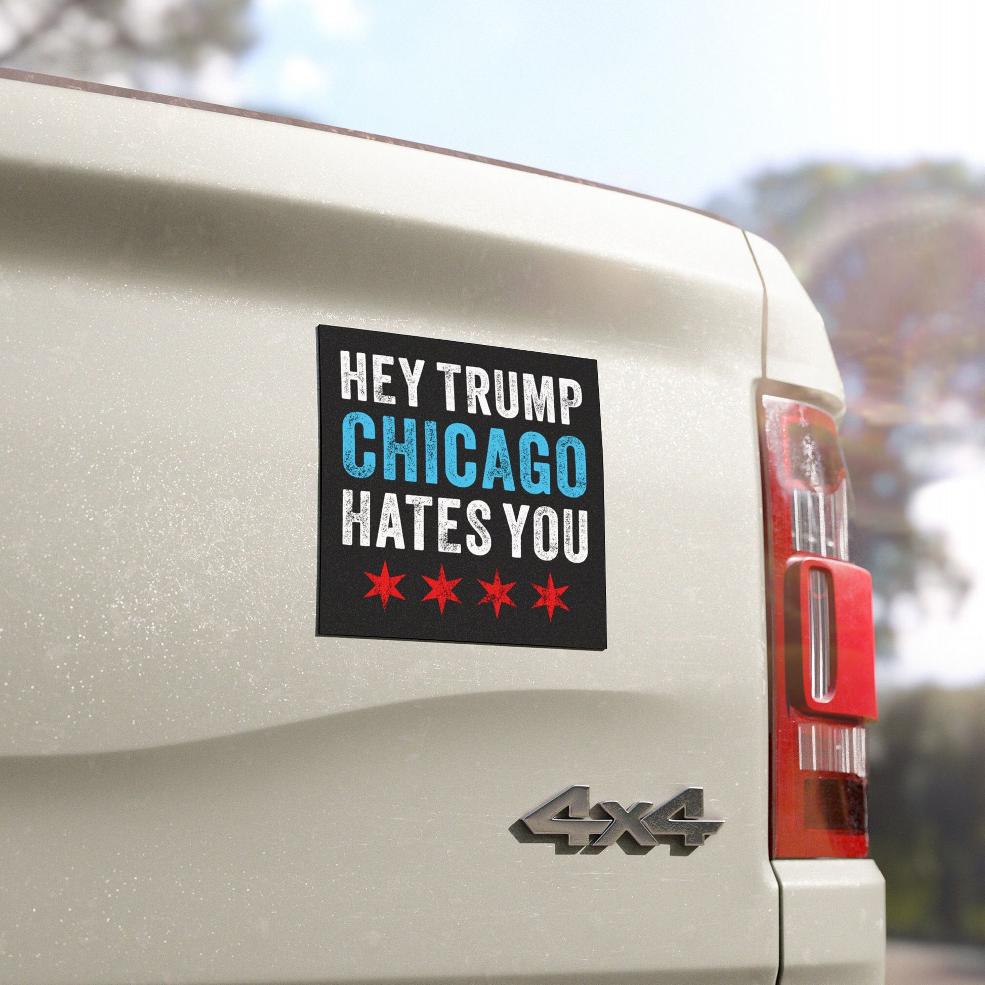 Chicago Hates Trump Sticker & Magnet displayed on a white 4x4 truck's tailgate, with bold lettering and distinctive Chicago flag stars, embodying Midwest resistance against MAGA politics and ICE brutality.