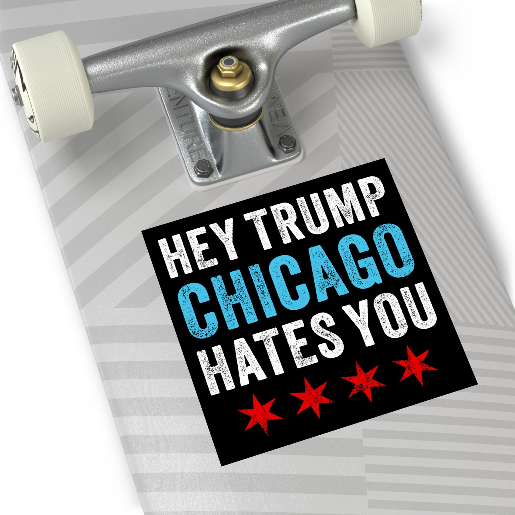 Chicago Hates Trump Sticker & Magnet on a light gray skateboard deck, featuring distressed white and blue text, four red stars, and visible skateboard truck, embodying Midwest resistance and activism.