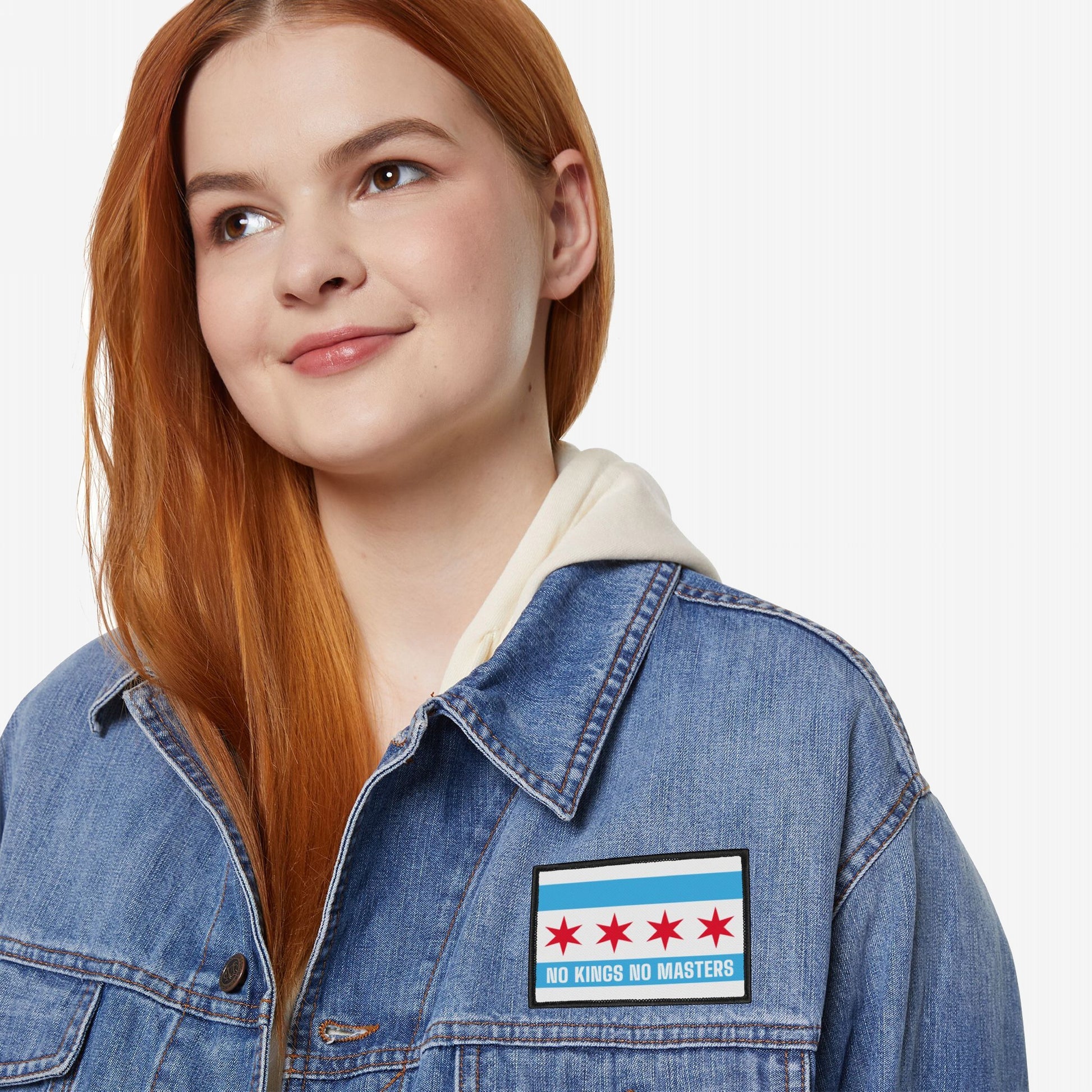 A young woman models the Chicago Flag No Kings Patch, featuring five red stars and NO KINGS NO MASTERS slogan on a denim jacket, embodying an anti-authoritarian message.
