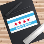 Chicago Flag No Kings Sticker & Magnet on a black drafting pad with a stylus and metal ruler, showcasing Chicago pride and anti-authoritarian message with city flag design and text.