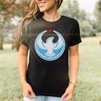 Chicago Rebel Alliance Women's Baby Tee featuring a white peregrine falcon in a light blue circle with a red star. Modeled outdoors, this tee exemplifies bold activism and Chicago pride.