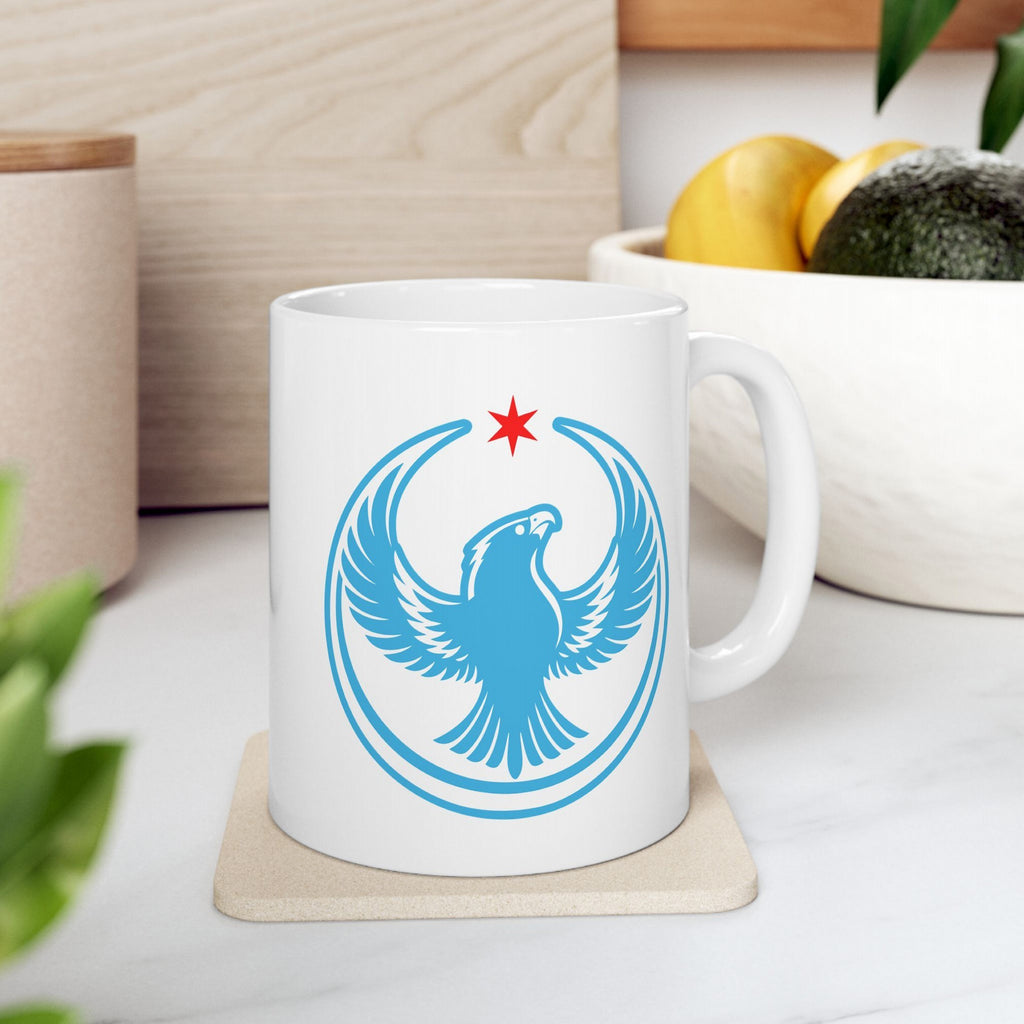 Chicago Rebel Alliance Mug with a stylized peregrine falcon graphic and red star, reflecting anti-fascist and immigrant rights support, sits on a cork coaster, embodying bold protest and Chicago pride.