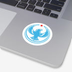 Chicago Rebel Alliance Sticker on a laptop palm rest, featuring a blue peregrine falcon with wings raised, encircled by a border, topped with a small red star. Represents anti-fascist protest art.