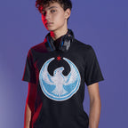 Teenage boy wearing a black Chicago Rebel Alliance T-shirt with a distressed eagle emblem, red star. Over-ear gaming headphones rest around his neck. Red accent lighting highlights his face and shoulder.