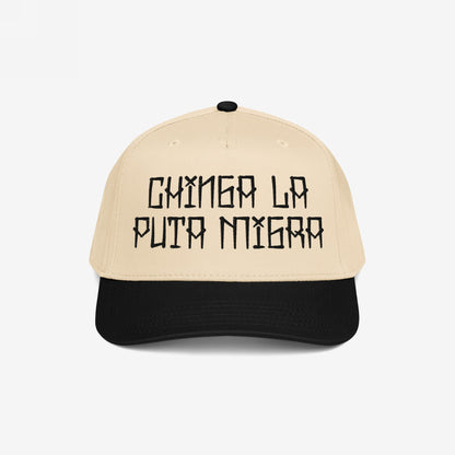 Two-tone Chinga La Migra Hat with a beige crown and black brim, featuring a bold black embroidered slogan GAMERA LA PUTA MIERDA, embodying resistance and defiance against oppressive systems.