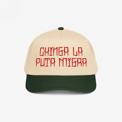 Two-tone Chinga La Migra Hat featuring a beige crown and dark green brim, embroidered with bold red Spanish text, embodying defiance against oppression and supporting equality and resistance movements.