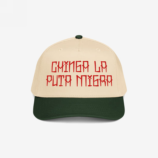 Two-tone Chinga La Migra Hat featuring a beige crown and dark green brim, embroidered with bold red Spanish text, embodying defiance against oppression and supporting equality and resistance movements.