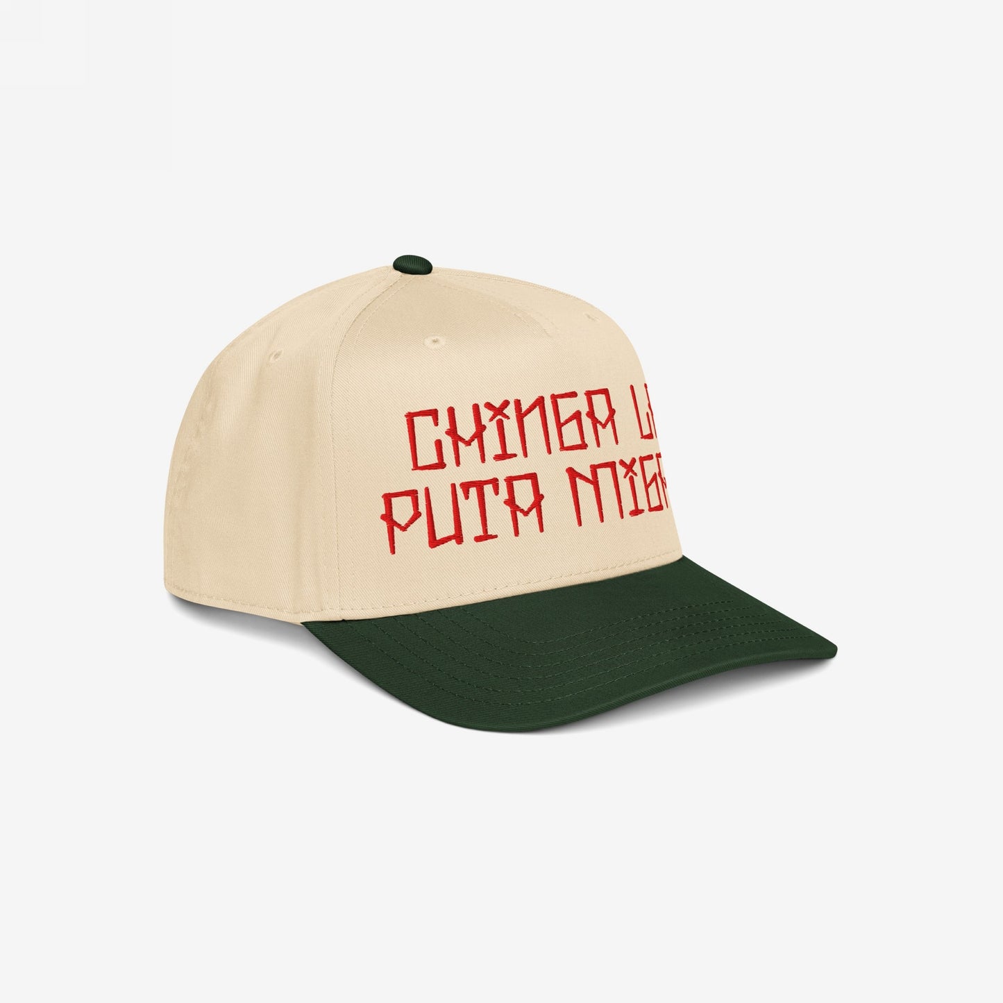 Chinga La Migra Hat featuring bold, red runic-style embroidery on a beige and forest green cap, embodying a strong stance against immigration enforcement and advocating for equality and resistance.