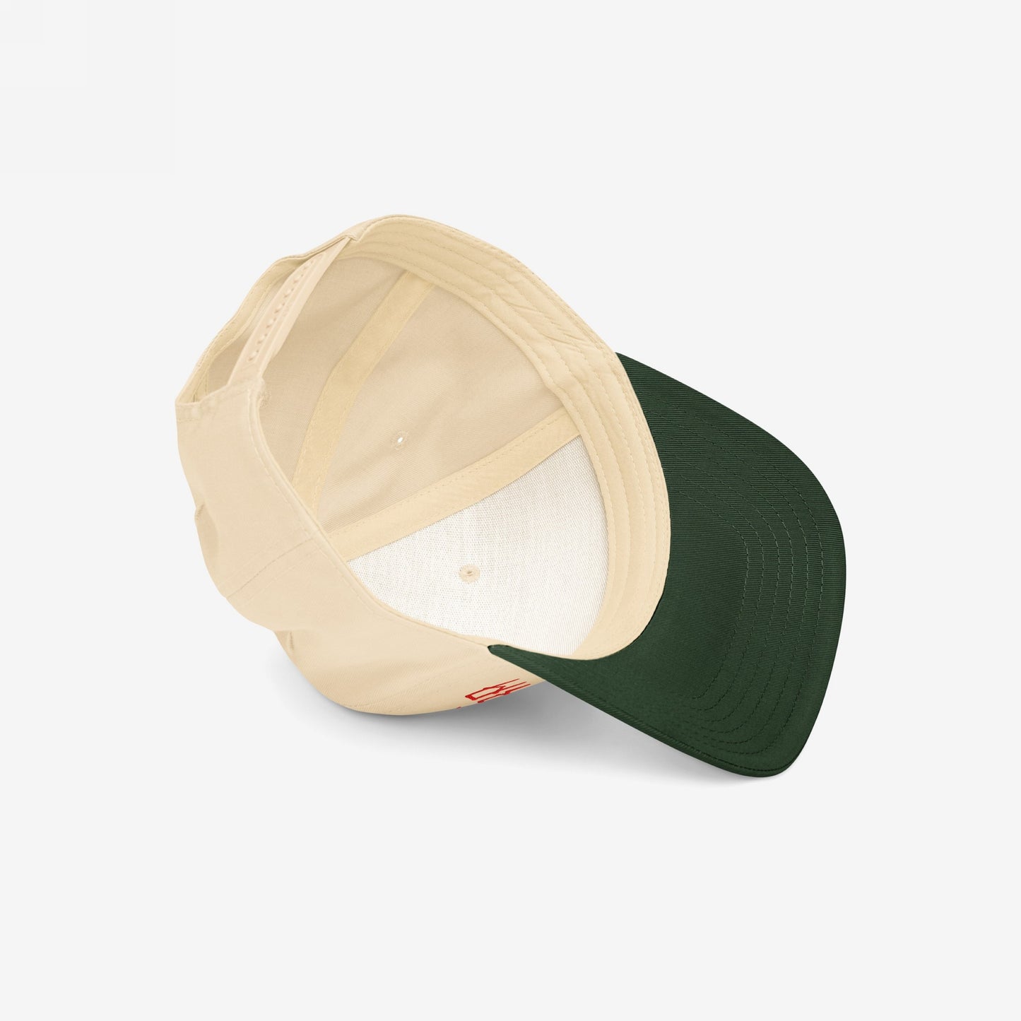 Chinga La Migra Hat displaying its embroidered message, visible light beige crown and sweatband, dark forest green brim, and adjustable back strap, reflecting bold resistance against oppression and injustice.