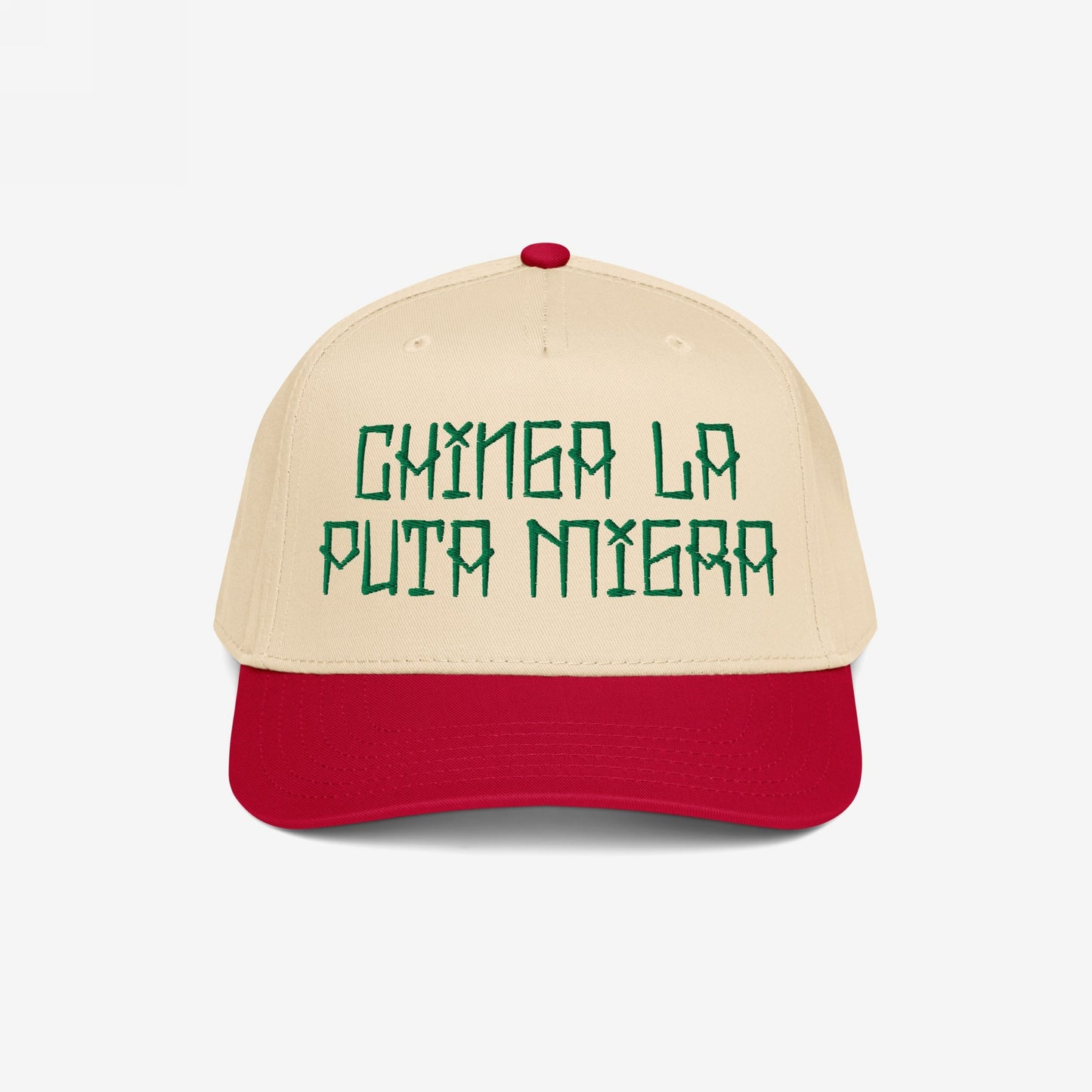Two-tone Chinga La Migra Hat featuring green embroidered phrase on light cream crown with bright red bill, embodying defiance against oppression and injustice, aligned with the store's commitment to resistance and equality.