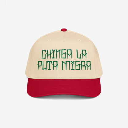 Two-tone Chinga La Migra Hat featuring green embroidered phrase on light cream crown with bright red bill, embodying defiance against oppression and injustice, aligned with the store's commitment to resistance and equality.