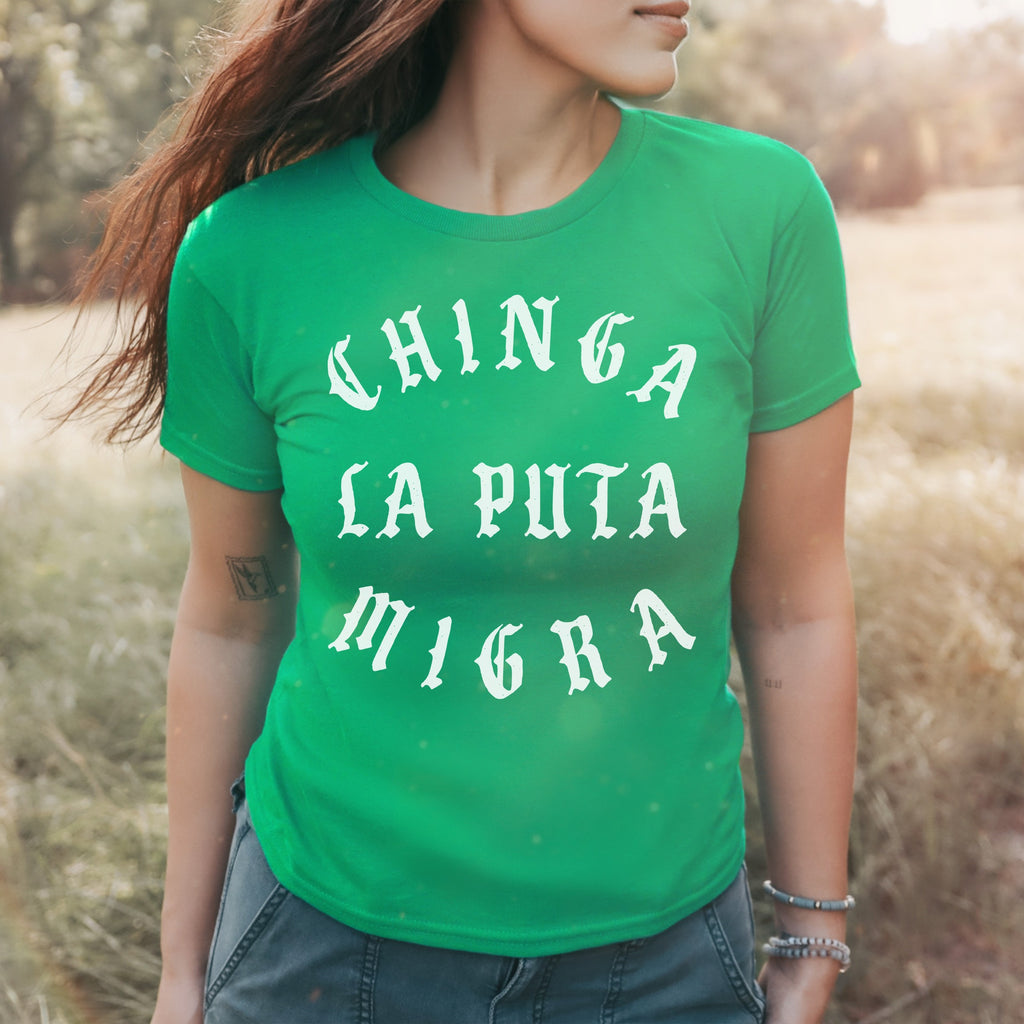 Person wearing the Chinga La Migra Women's Baby Tee with bold, white gothic text stating CHINGA LA PUTA MIGRA, embodying a statement against ICE, perfect for activists and supporters of equality.