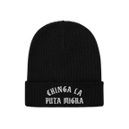 Chinga La Migra Hat: A black rib-knit beanie with gothic white embroidery stating “CHINGA LA PUTA MIGRA,” symbolizing ant