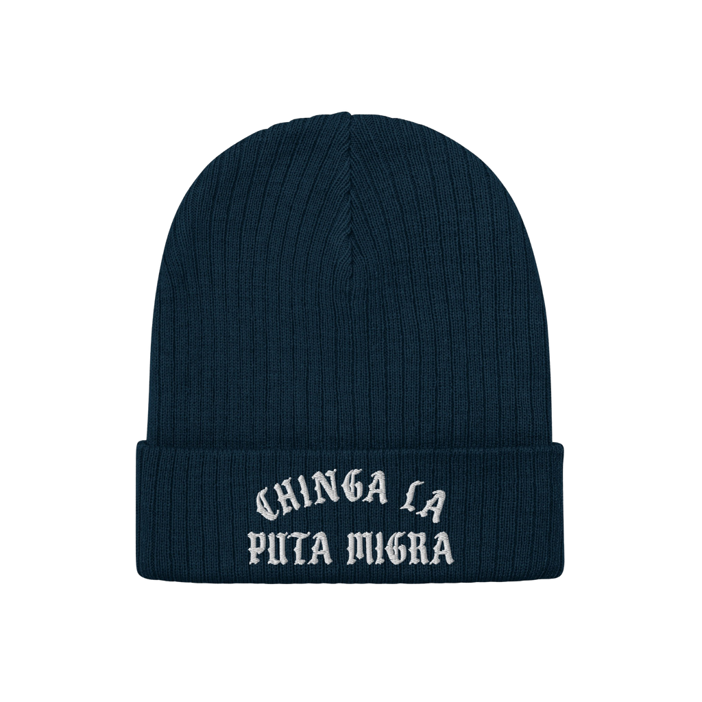 Chinga La Migra Hat: Dark navy-blue knit beanie with a folded cuff, featuring CHINGA LA PUTA MIGRA in white old-English–sty