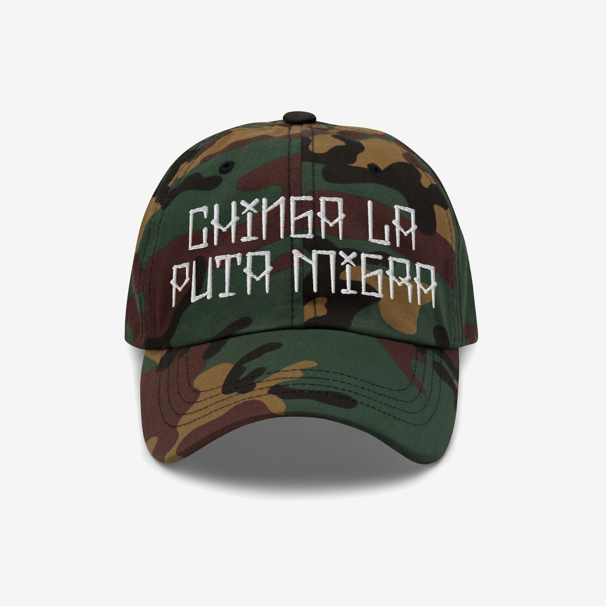 Camouflage-print baseball cap with hand-stitched embroidery reading Chinga La Migra, boldly confronting immigration enforcement. The cap is a statement piece against oppression, available in various styles.