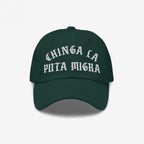 Dark green Chinga La Migra Hat with white CHINGA LA PUTA MIGRA text, a bold statement against CBP/ICE, perfect for anti-fascist advocates and immigrant rights supporters.