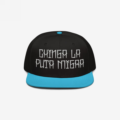 Snapback-style Chinga La Migra Hat with a black crown and turquoise brim, featuring the bold, embroidered phrase “CHINGA LA PUTA MIGRA” in white, symbolizing resistance against oppressive immigration systems.