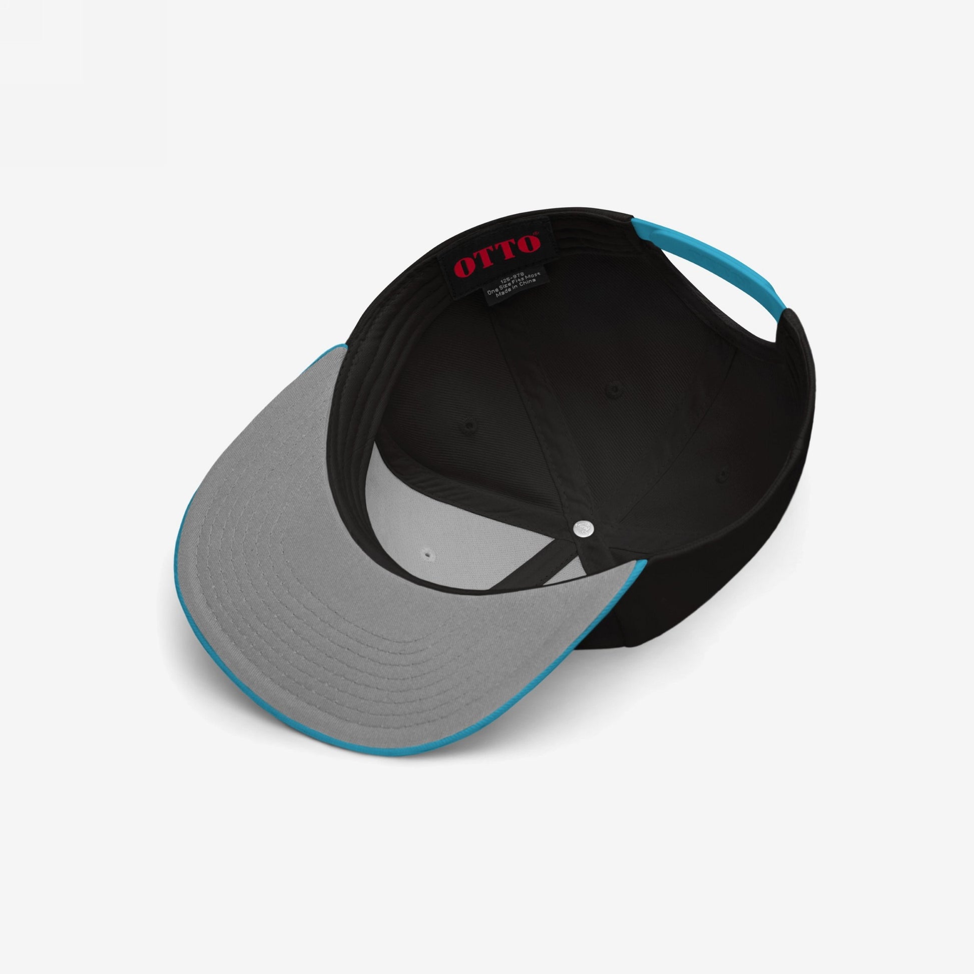 Chinga La Migra Hat's interior features a black crown and sweatband, with an OTTO label. It has a bright cyan adjustable snap closure and a gray bill underside with cyan trim.