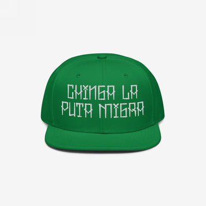 Green flat-brim cap with “CHINGA LA PUTA MIGRA” embroidered in white, symbolizing bold resistance against immigration injustices. The Chinga La Migra Hat embodies defiance and solidarity with marginalized communities.