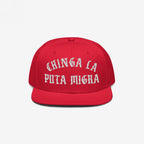 Chinga La Migra Hat: A bold red snapback featuring white Old English embroidery with the phrase CHINGA LA PUTA MIGRA, embodying anti-fascist and immigrant rights advocacy.