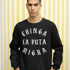 Young man in a black Chinga La Migra Hoodie & Sweatshirt with bold, white Old English text, protesting against CBP/ICE.