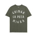 Chinga La Migra T-shirt displaying the phrase “Chinga la puta migra” in white Gothic-style lettering on a solid green bac