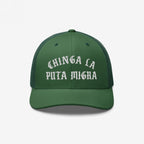 Dark green Chinga La Migra trucker hat with white Gothic text, mesh back, and curved brim, embodying anti-fascist sentiment and immigrant rights advocacy. Perfect for bold statements and protest solidarity.