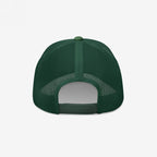 The back of the Chinga La Migra Hat features a dark-green trucker style with mesh panels and an adjustable snap-closure strap, embodying a bold anti-fascist message for immigrant rights advocates.