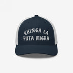 Chinga La Migra Hat: A navy trucker cap with bold Old English embroidery, embodying anti-fascist sentiment. Ideal for those advocating immigrant rights and challenging CBP/ICE practices.