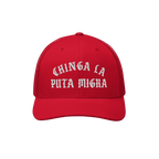 Chinga La Migra Hat with bold Old English-style white embroidery, Chinga La Puta Migra, on a red trucker cap, embodying anti-