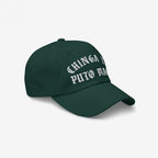 The Chinga Tu MAGA Hat is a dark-green baseball cap featuring bold, white Old-English embroidery with a Spanish slogan, symbolizing anti-fascist and anti-MAGA sentiments.