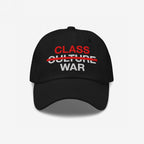 Class War Hat featuring bold embroidery: CLASS in red, CULTURE crossed out, and WAR in white, symbolizing a focus on economic justice over cultural distractions. Available in various hat styles.