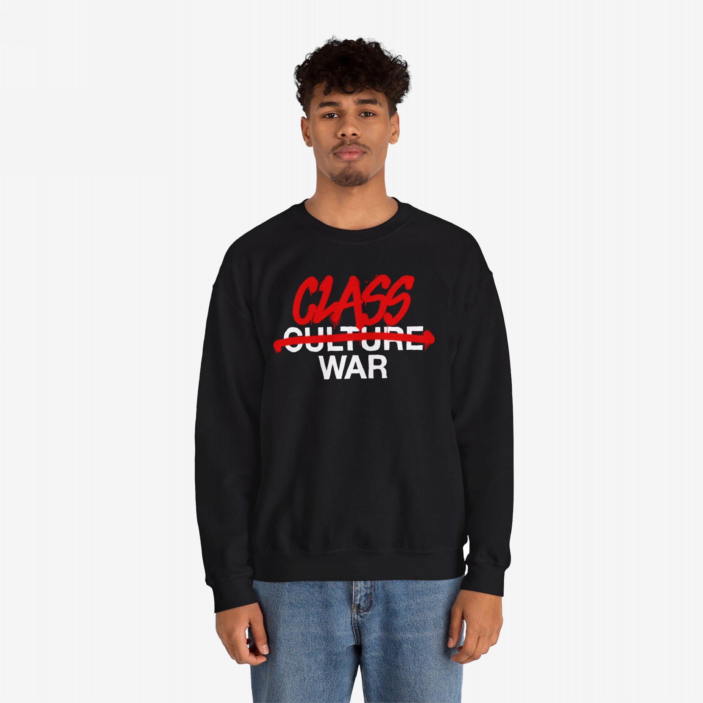 Male model wears Class War Shirt, featuring graffiti-style CLASS WAR message over CULTURE WAR on a black sweatshirt. The design aligns with themes of activism and social justice.
