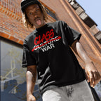 Young man in a Class War Shirt, featuring red graffiti altering Culture War to Class War, embodies activism. Casual style with light-wash jeans, reflecting bold, leftist messaging.