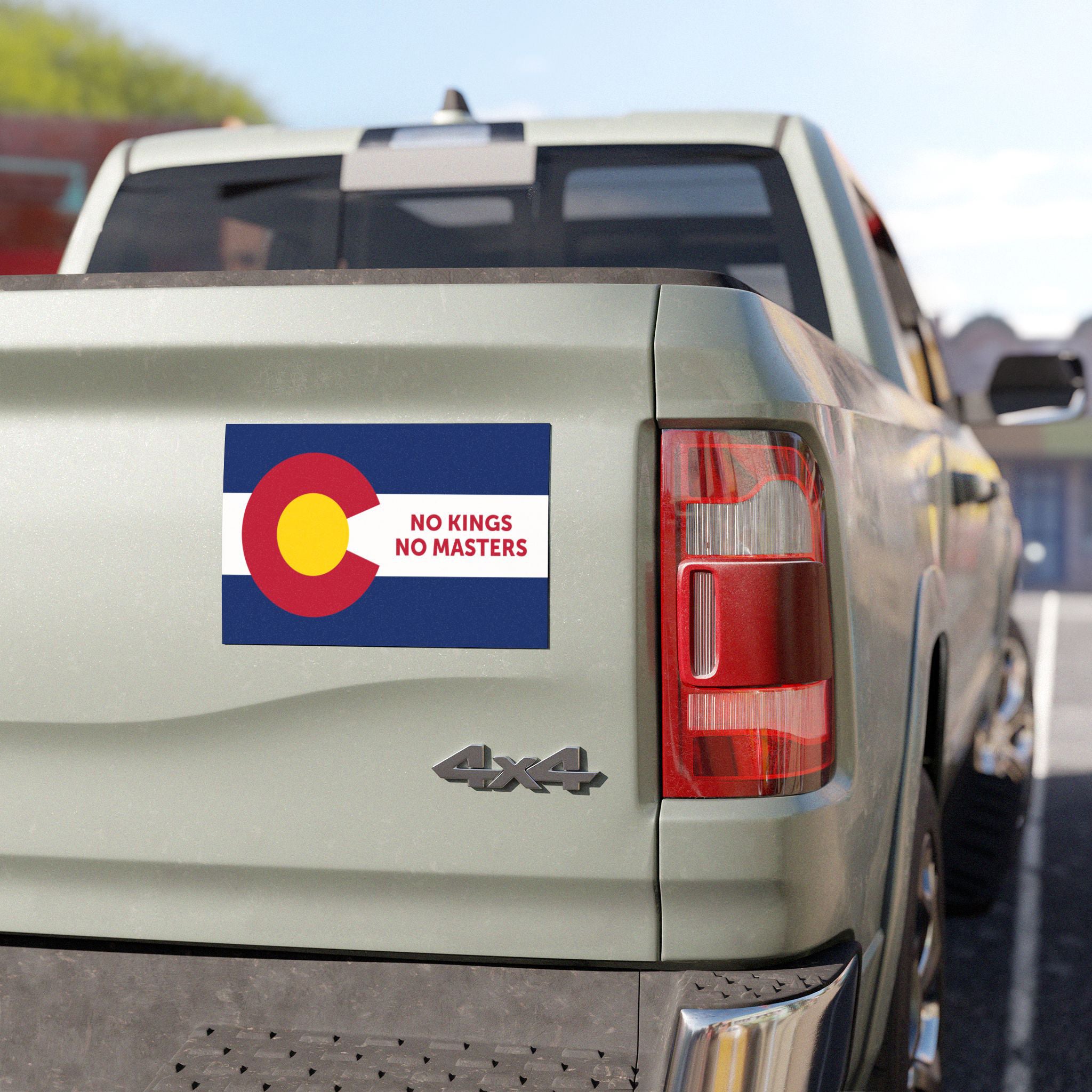 A 4x4 pickup truck tailgate features the Colorado Flag No Kings Sticker & Magnet, showcasing a modified state flag with NO KINGS NO MASTERS text, symbolizing resistance.